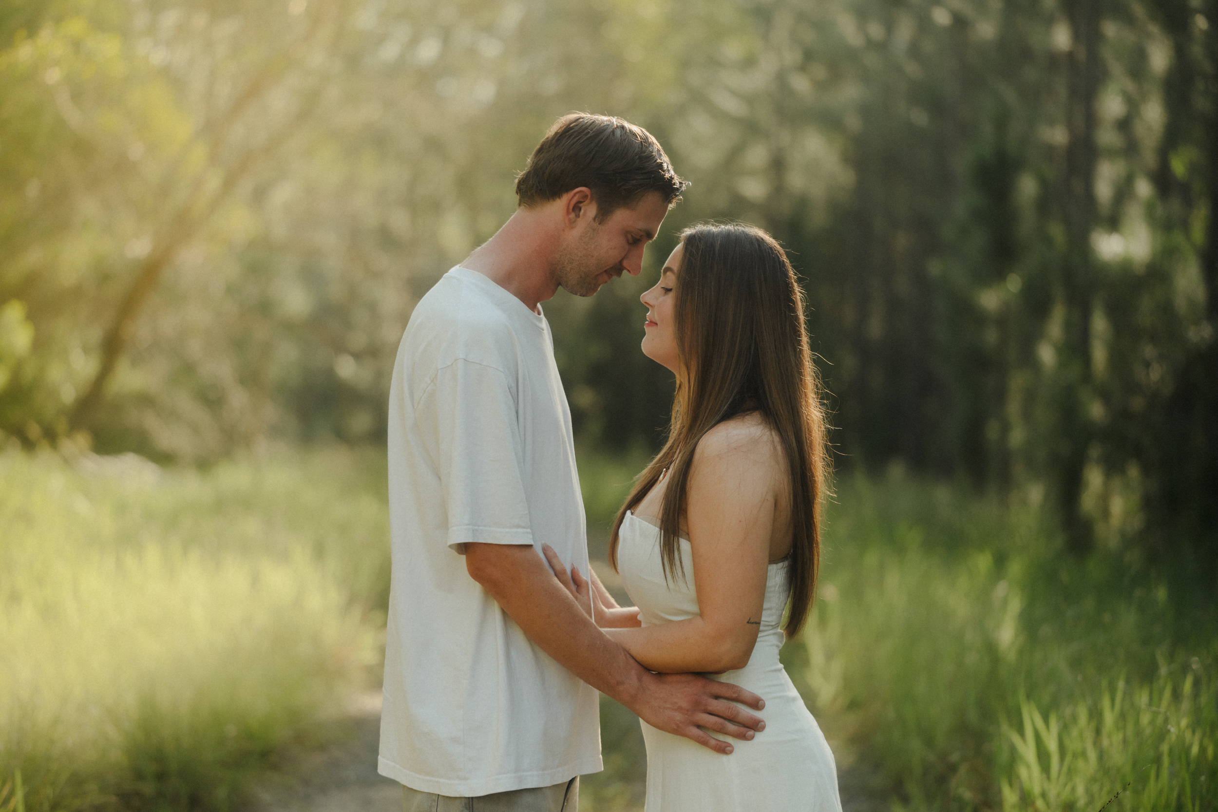 Couple in lush green golden-light field
